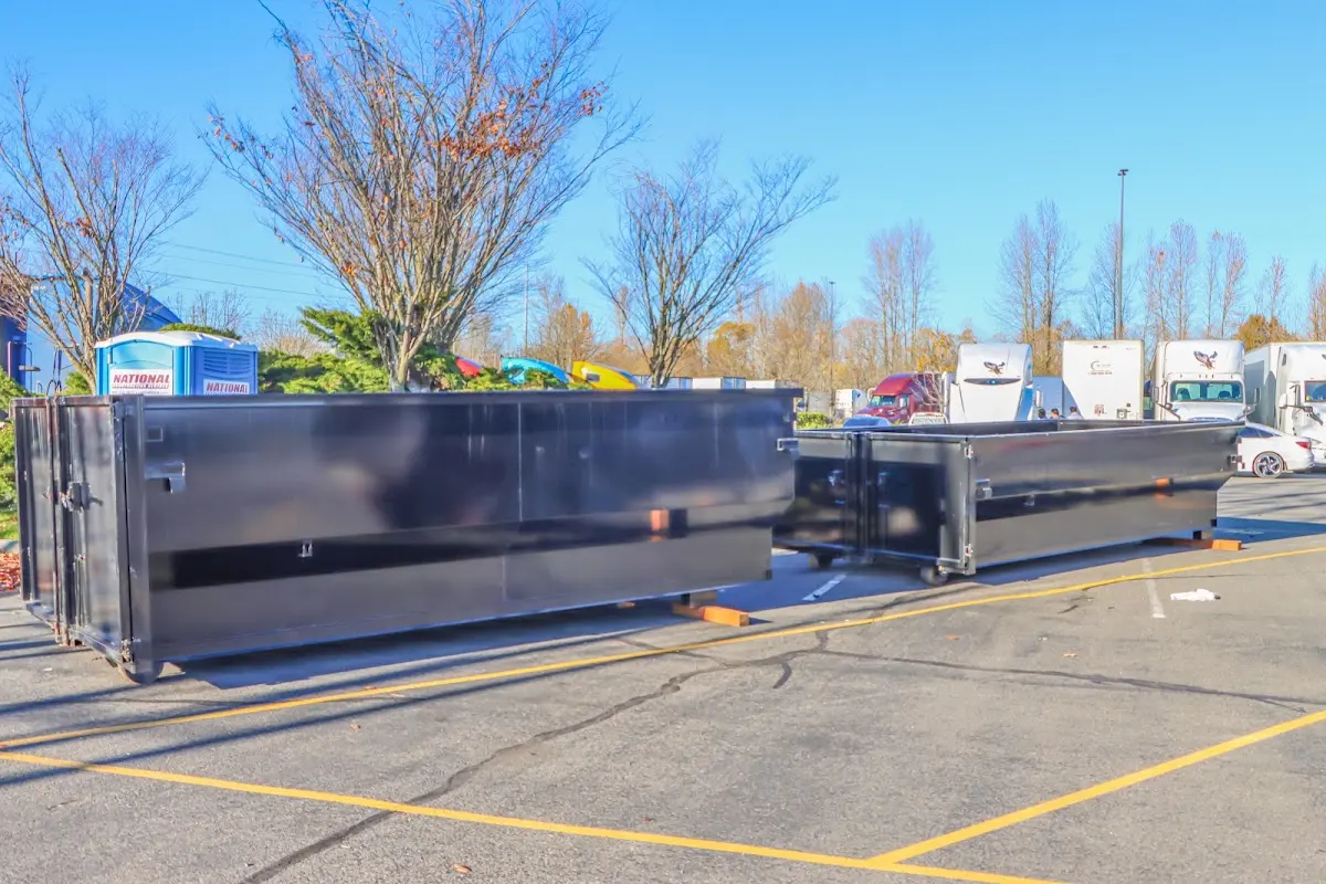 Professional dumpster rental service with roll-off container on residential driveway in Greeneville